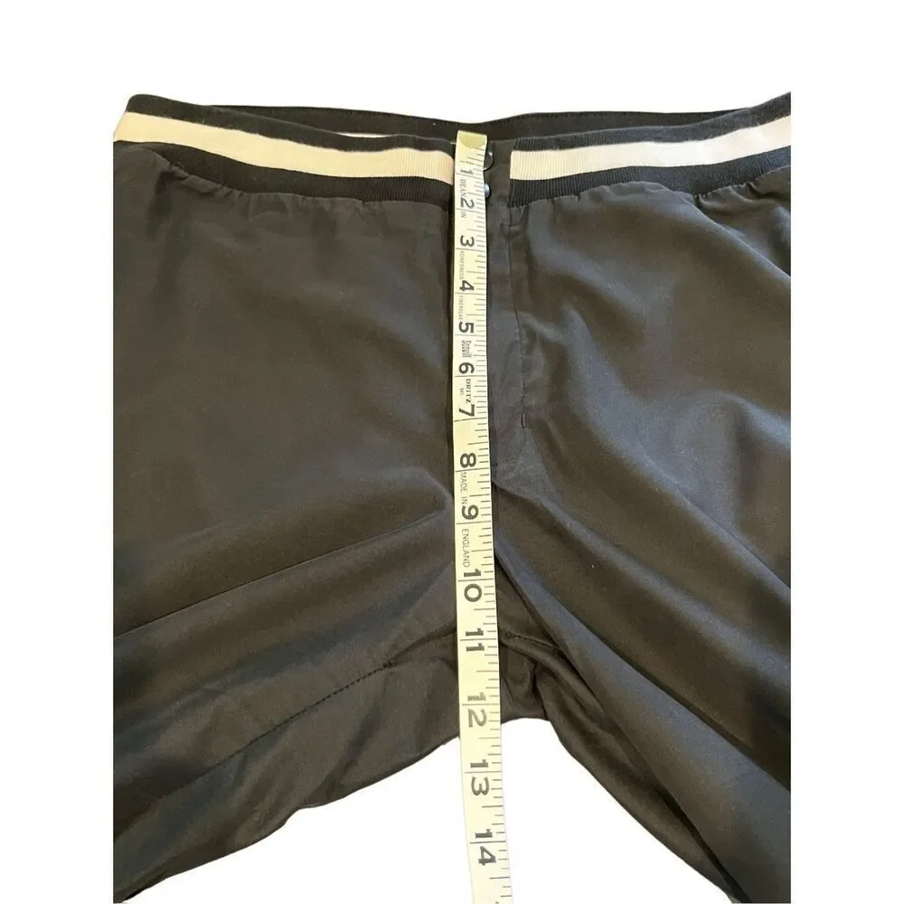 Nike black track pants with white side stripes and ankle zippers - L